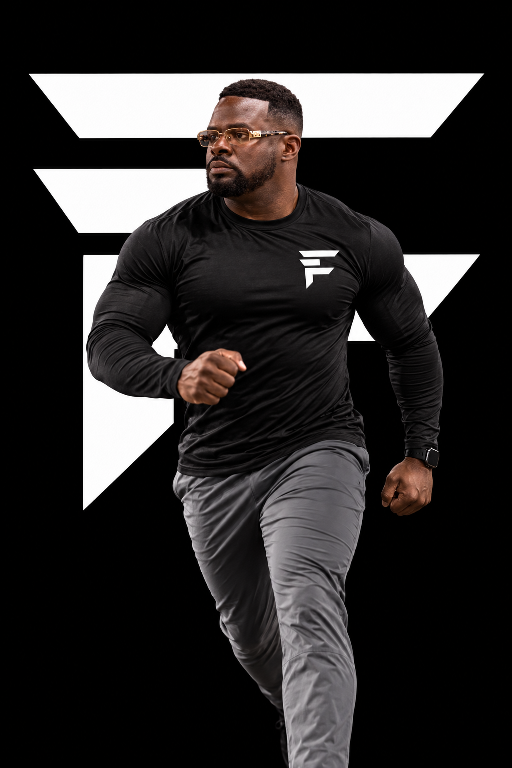 Coach Tavarus R. Finley driving forward in a black performance shirt